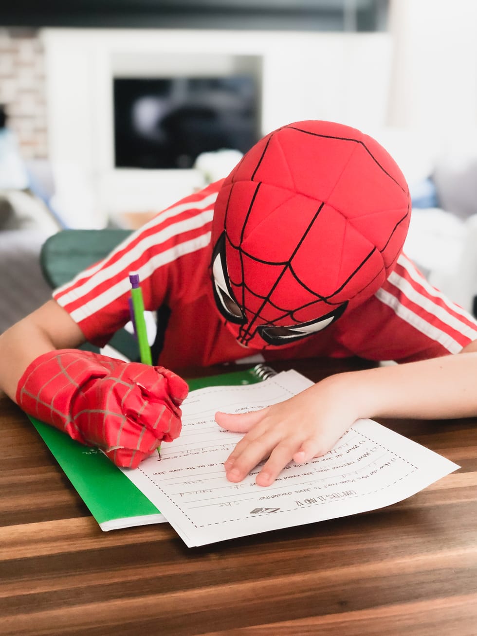 boy working on homeschool work at kitchen table