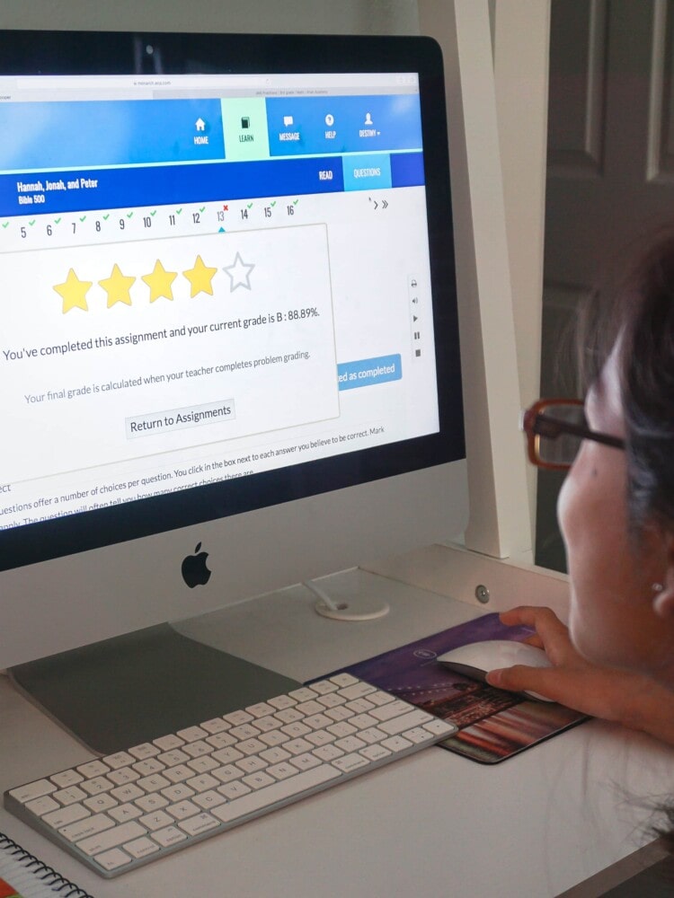 a girl completing a homeschool assignment on the computer using monarch