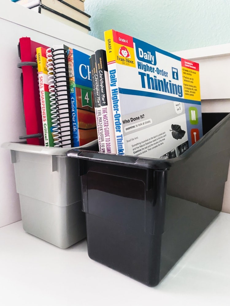 a bin holding several workbooks and notebooks