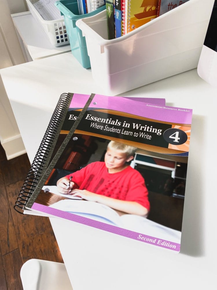 essentials in writing level 4 workbooks sitting on a white desk