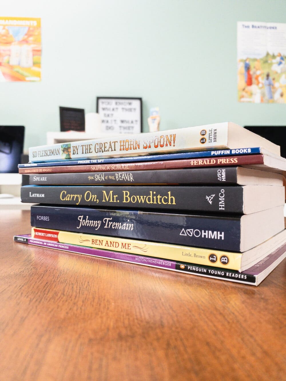 a collection of history literature for 4th grade homeschool curriculum sitting on a desk