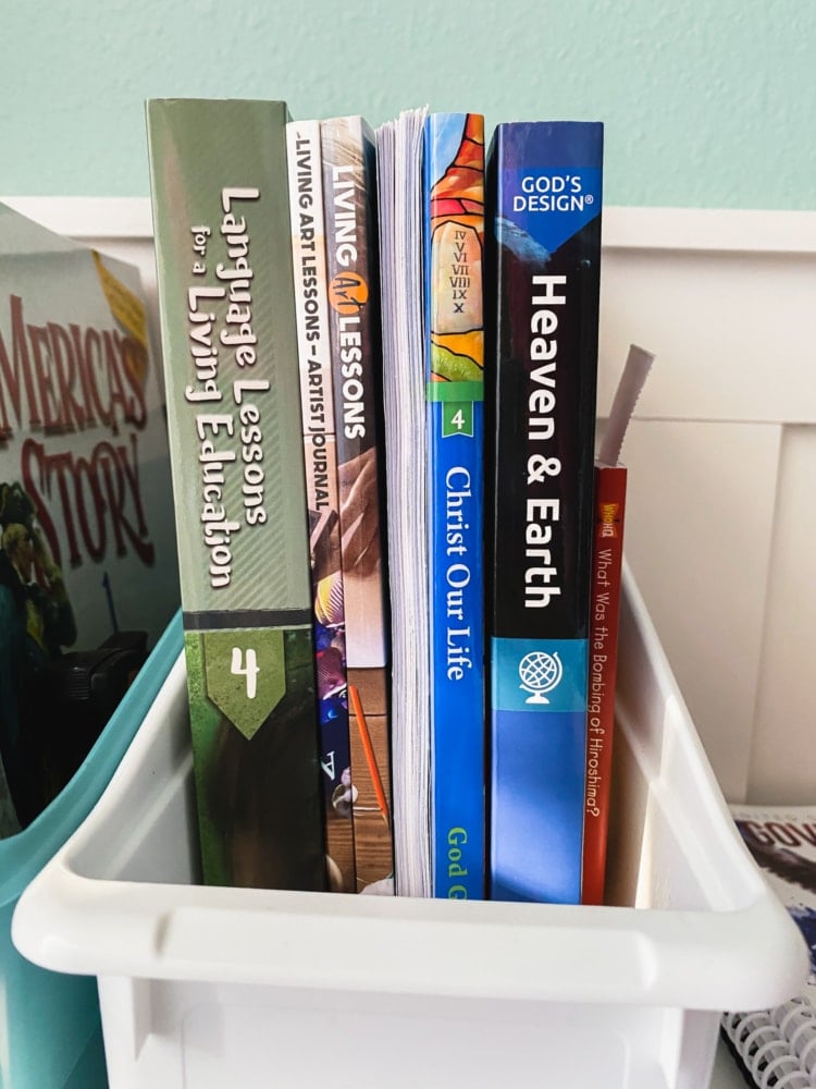 several homeschool curriculum books standing on a desk