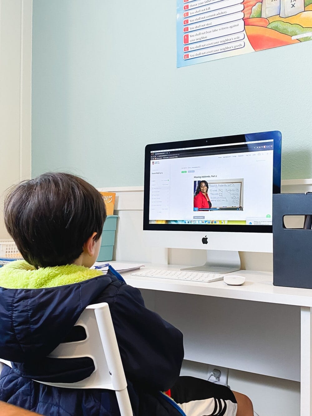 a young boy sitting in front of a desktop computer displaying nicole the math lady homeschool math support for saxon math