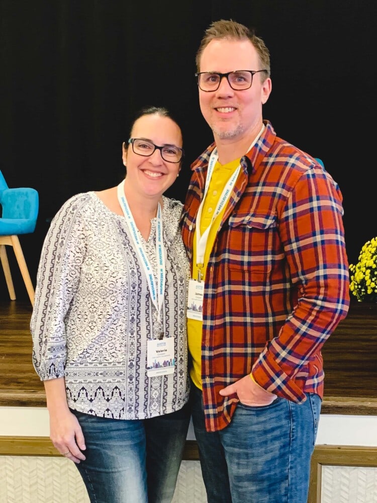 valerie and ryan posing together in front of a stage