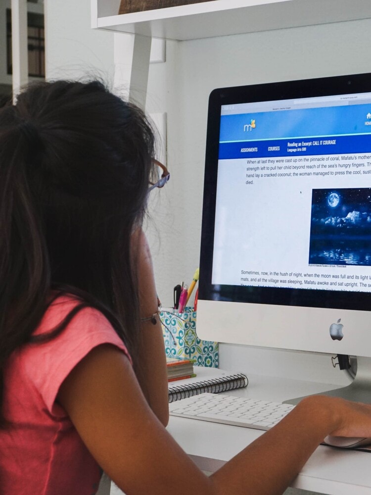 a girl doing homeschool work on the computer