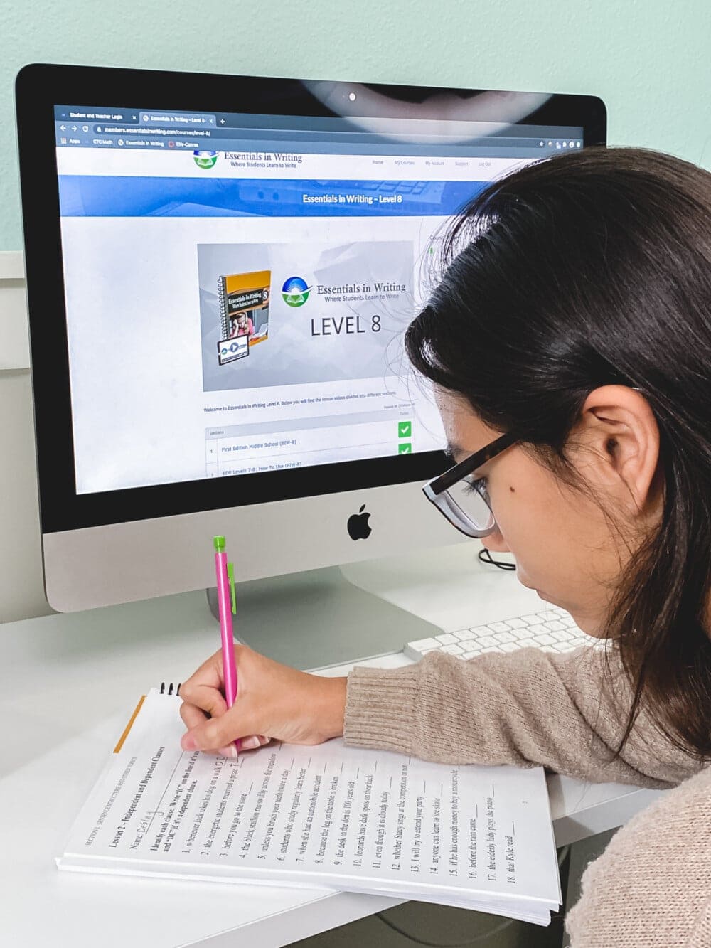 a girl using a computer to do her homeschool english work